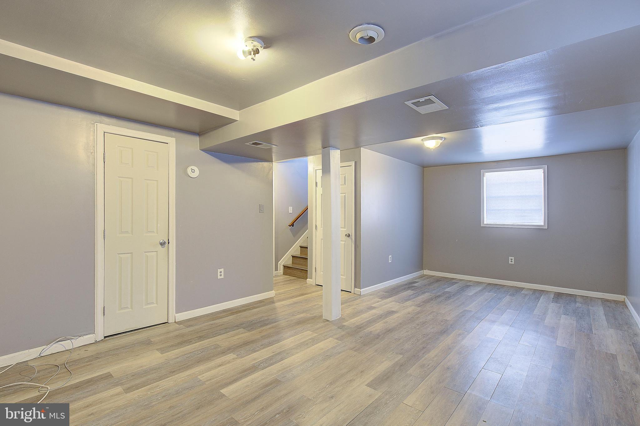 3611 Blackwater Road Clinton, MD 20735 - Photo 17 of 31 an empty room with wooden floor and windows