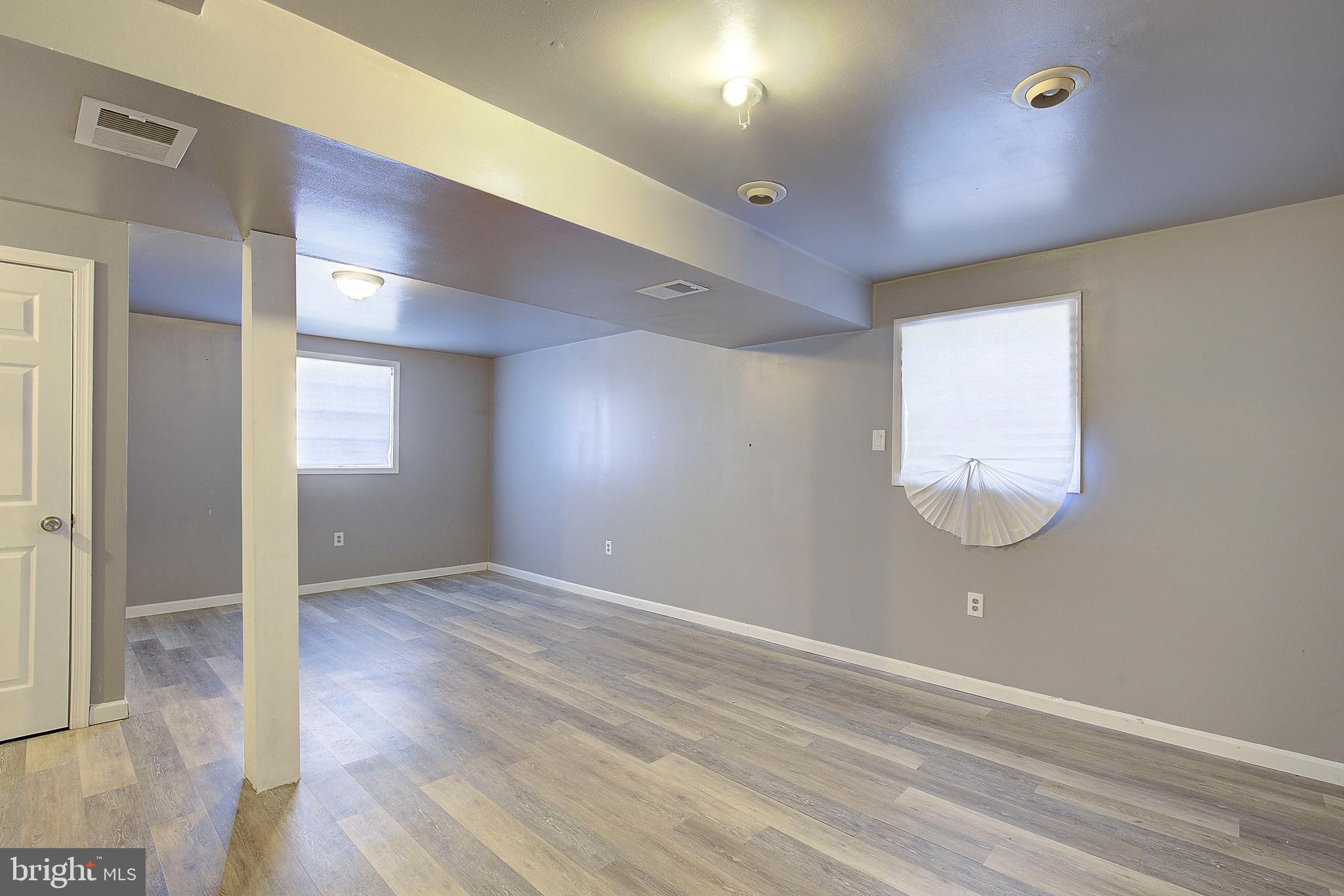3611 Blackwater Road Clinton, MD 20735 - Photo 18 of 31 an empty room with wooden floor and windows