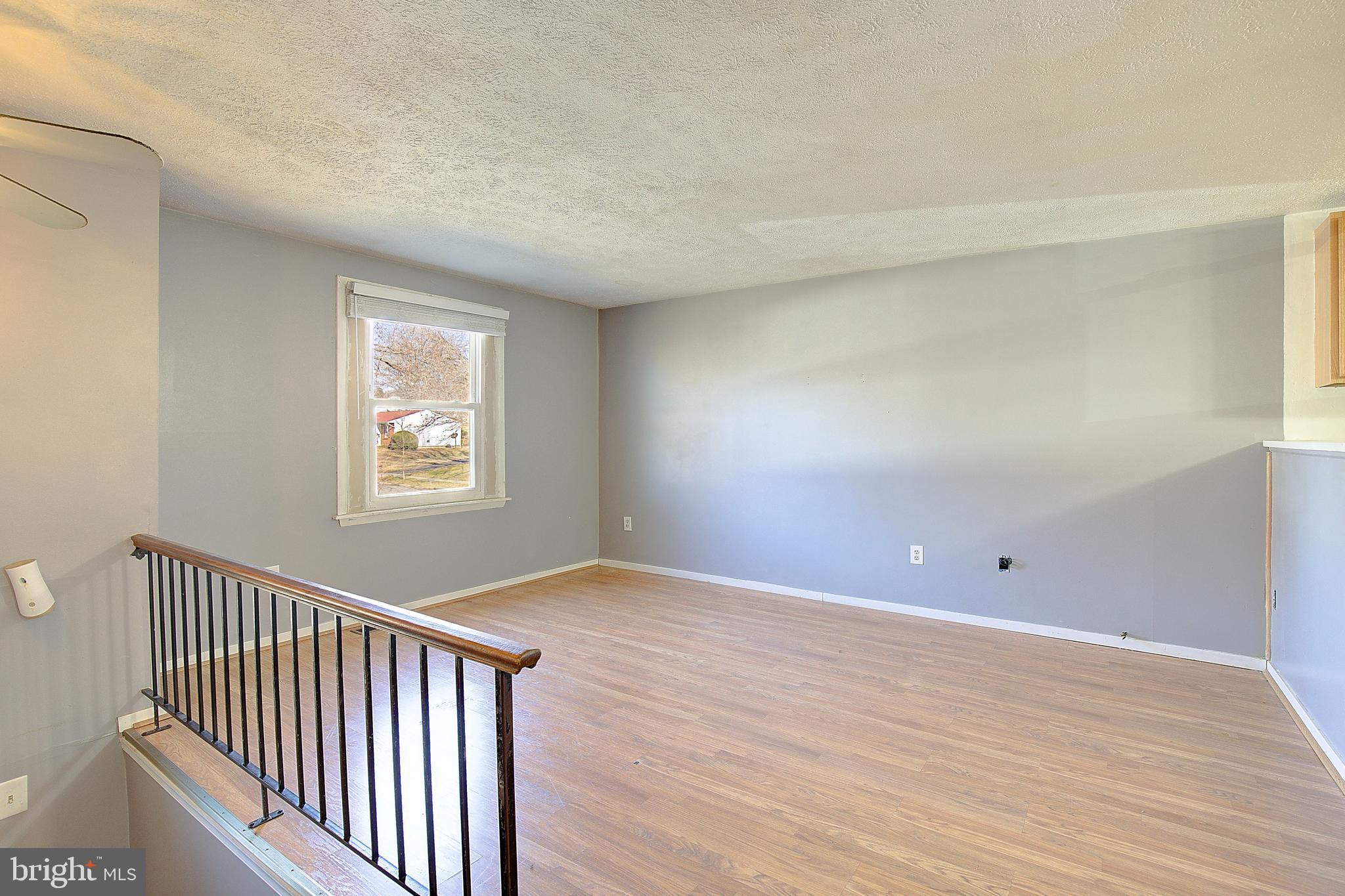 3611 Blackwater Road Clinton, MD 20735 - Photo 2 of 31 a view of an empty room with wooden floor and a window