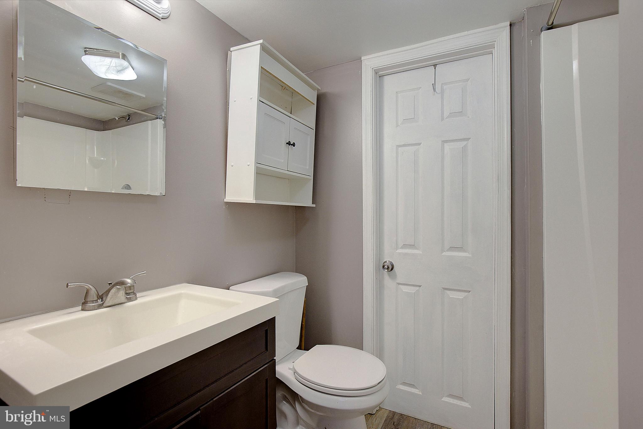 3611 Blackwater Road Clinton, MD 20735 - Photo 22 of 31 a bathroom with a toilet a sink and mirror