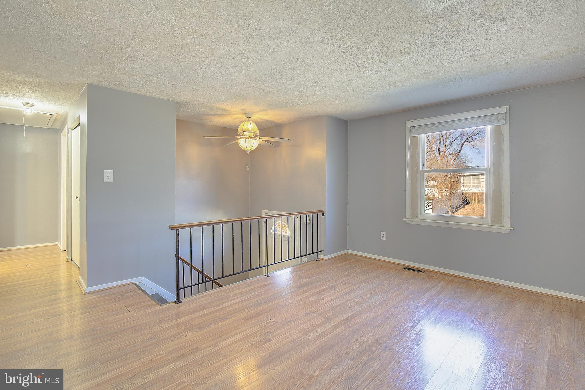 3611 Blackwater Road Clinton, MD 20735 - Photo 3 of 31 a view of an empty room with wooden floor and a window