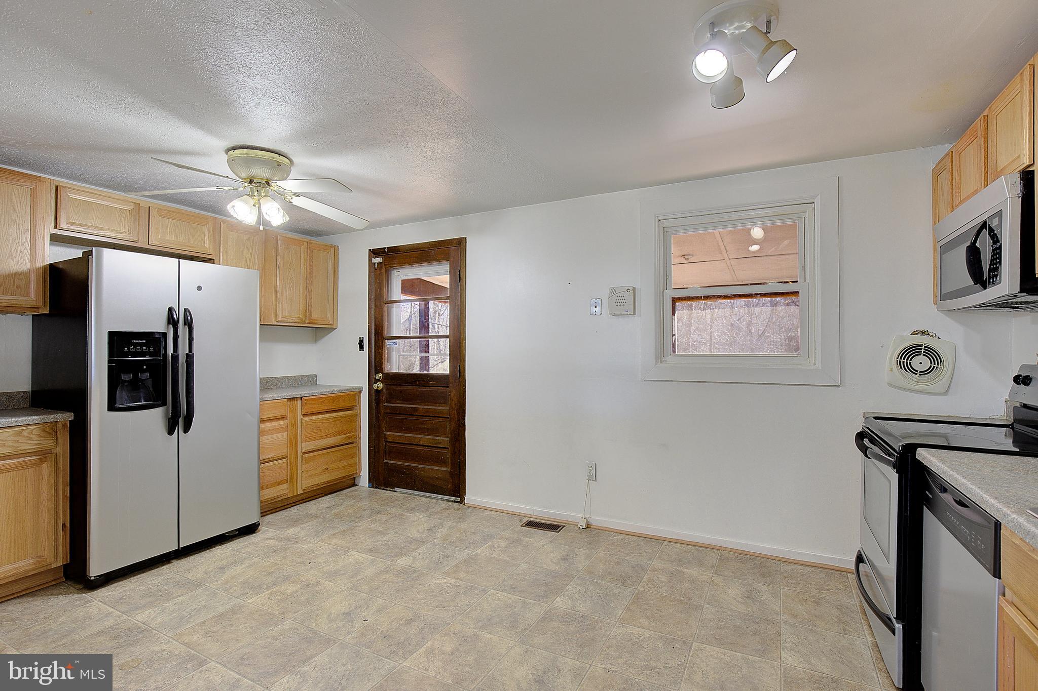 3611 Blackwater Road Clinton, MD 20735 - Photo 6 of 31 a kitchen with stainless steel appliances a refrigerator a stove a sink a oven and cabinets