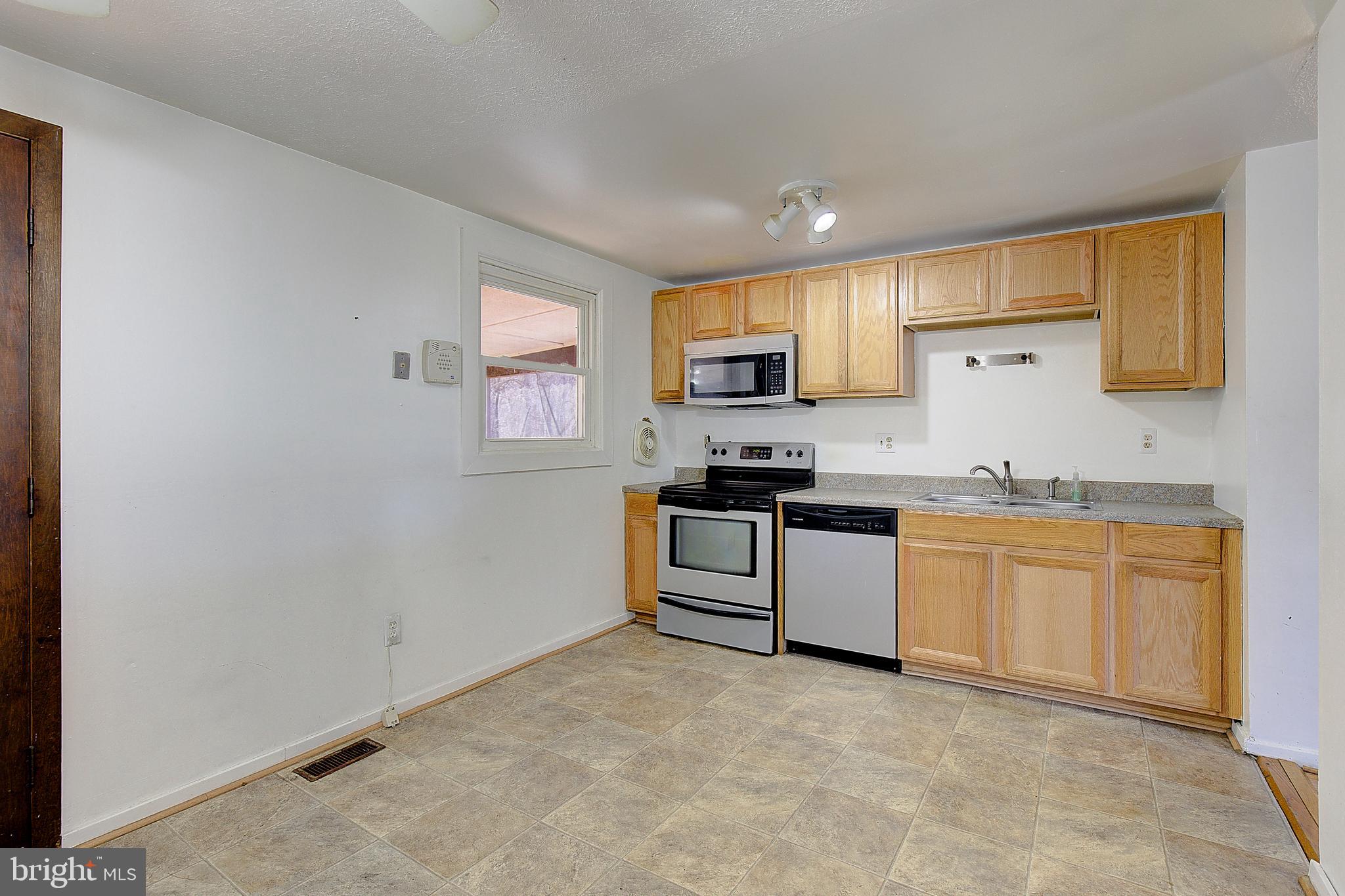 3611 Blackwater Road Clinton, MD 20735 - Photo 7 of 31 a kitchen with granite countertop white cabinets and stainless steel appliances