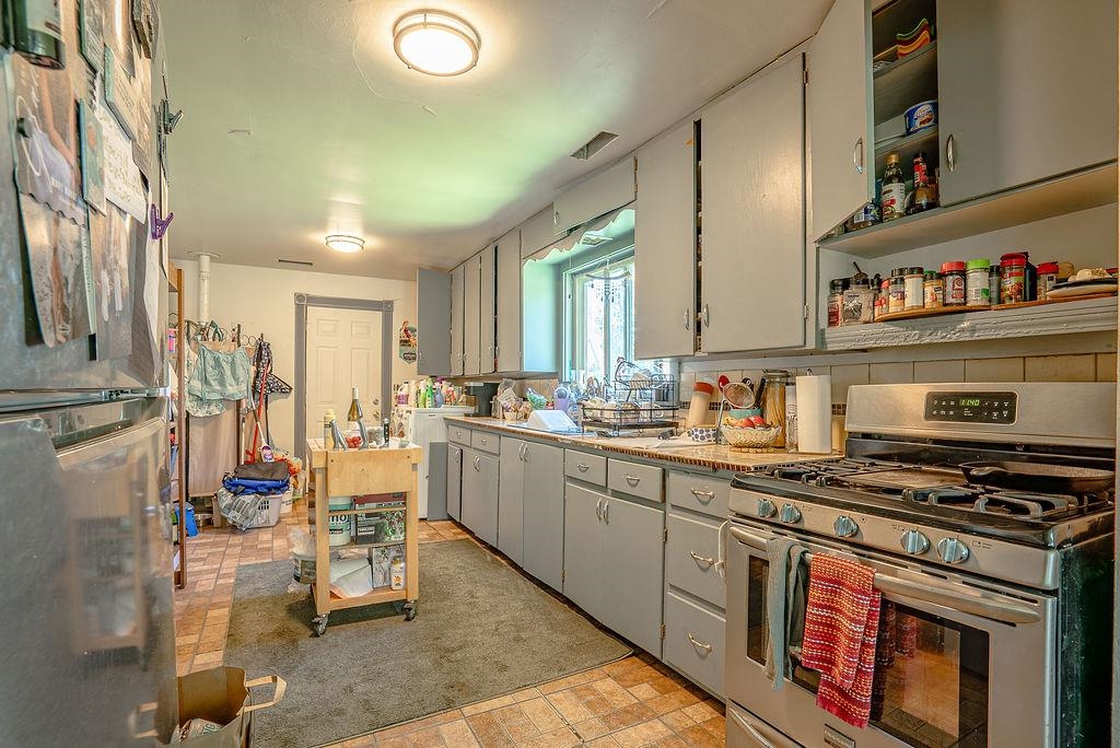 470 Riverside Avenue Chester, CA 96020 - Photo 9 of 25 a kitchen with stainless steel appliances a stove a sink and cabinets