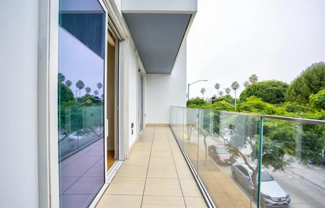 a balcony with view of outdoor space