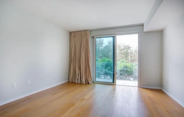 a view of room with window and wooden floor