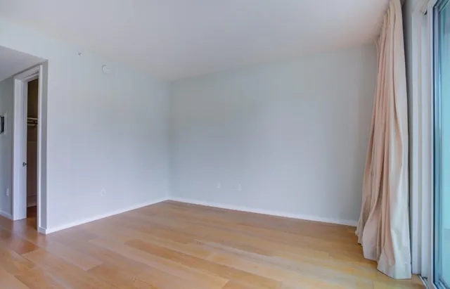 a view of an empty room and wooden floor