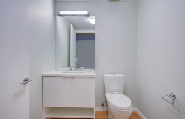 a white toilet sitting next to a bathroom sink