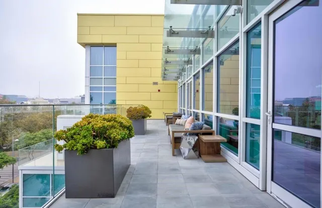 a lobby with furniture and potted plant
