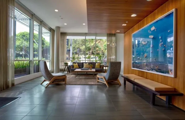 a living room with furniture and floor to ceiling windows
