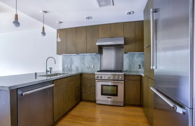 a kitchen with a sink and a stove top oven