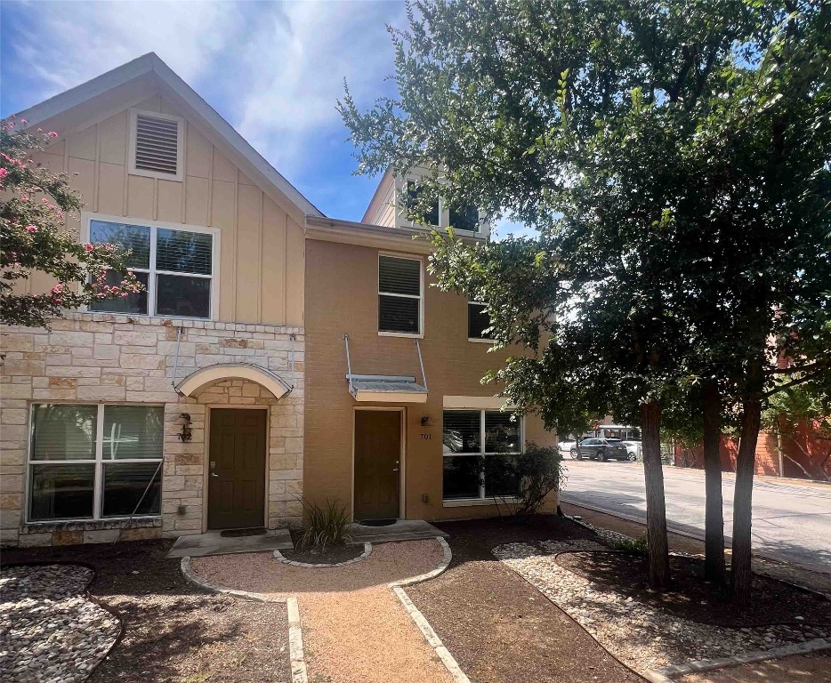 1101 Grove Boulevard, Unit 701 Austin, TX 78741 - Photo 1 of 16 a front view of a house with a garden