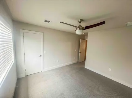 a view of a room with a ceiling fan