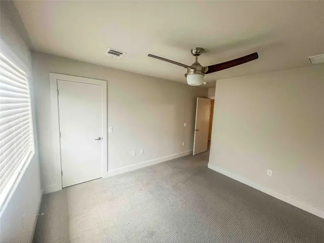 a view of a room with a ceiling fan
