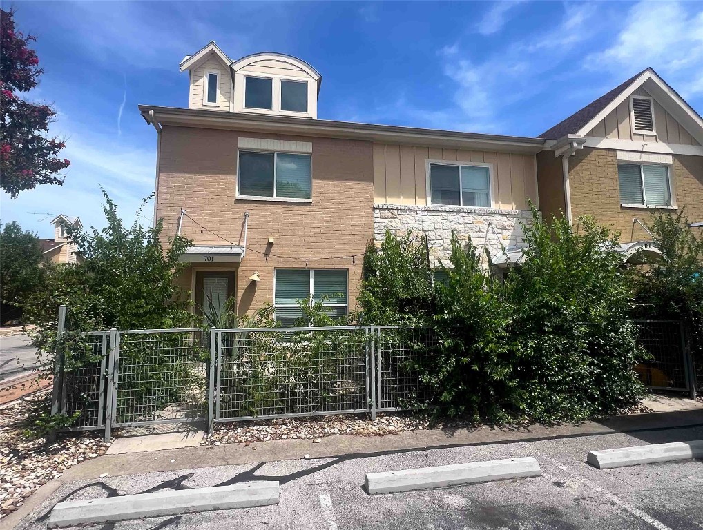 1101 Grove Boulevard, Unit 701 Austin, TX 78741 - Photo 2 of 16 a front view of a house with a garden