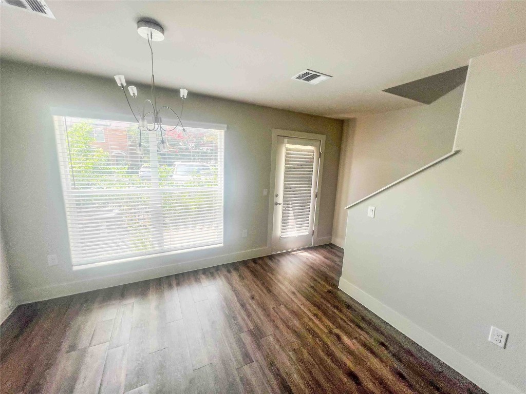 1101 Grove Boulevard, Unit 701 Austin, TX 78741 - Photo 3 of 16 an empty room with wooden floor and windows
