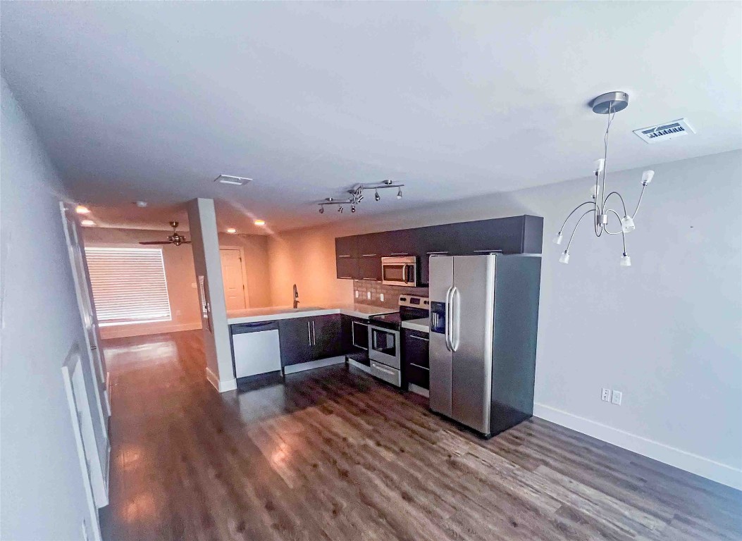 1101 Grove Boulevard, Unit 701 Austin, TX 78741 - Photo 4 of 16 a kitchen with stainless steel appliances a refrigerator and a stove top oven