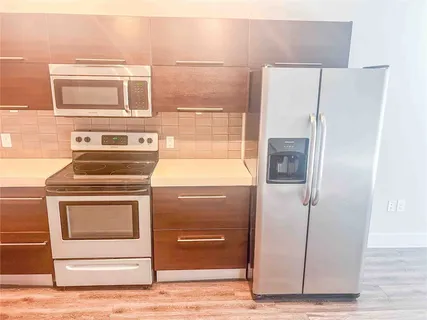 a kitchen with a stove and a refrigerator