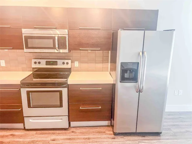 a kitchen with a stove and a refrigerator