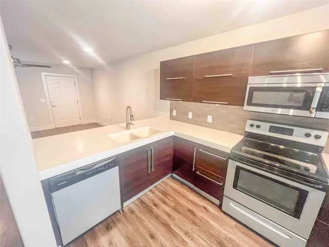 a kitchen with a sink stove and cabinets