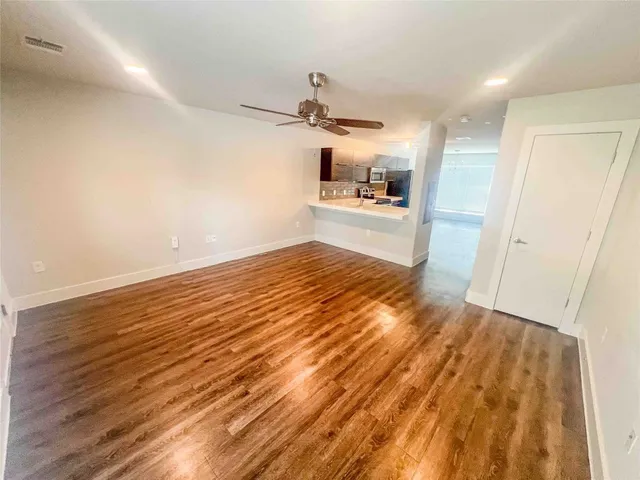 a view of a kitchen with wooden floor