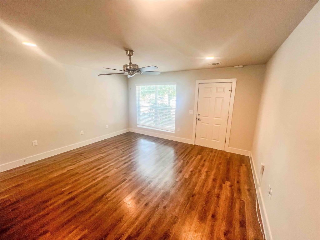 1101 Grove Boulevard, Unit 701 Austin, TX 78741 - Photo 9 of 16 a view of an empty room with wooden floor and a window