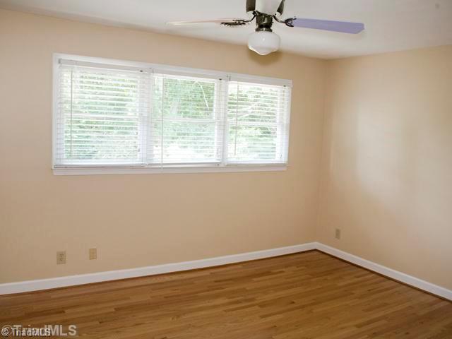 5811 Billet Road Oak Ridge, NC 27310 - Photo 14 of 16 3rd Bedroom. Additional home features include: sound system, full office (not pictured) on main level, 2 fireplaces (one woodburning), intercom, natural gas water heater, oversized rear deck, great storage, finished and unfinished basement, and much more!
