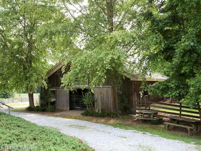 5811 Billet Road Oak Ridge, NC 27310 - Photo 4 of 16 Stable/Barn. The main barn has wonderful tack room, feed room, massive hay storage with easy load, 12 x 12 stalls and front and rear sliding doors. Situated under cooling shade trees. Shavings and equipment shed right next door.