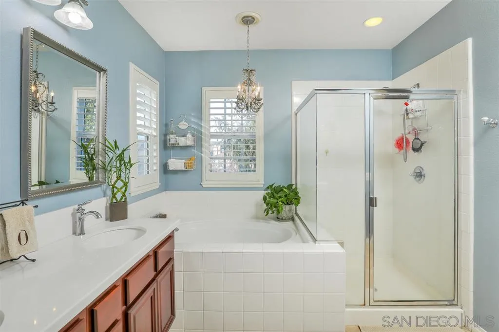 16691 Deer Ridge Road San Diego, CA 92127 - Photo 11 of 20 a bathroom with a granite countertop shower a mirror and a sink