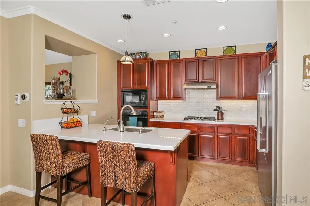 16691 Deer Ridge Road San Diego, CA 92127 - Photo 5 of 20 a kitchen with a sink refrigerator and cabinets