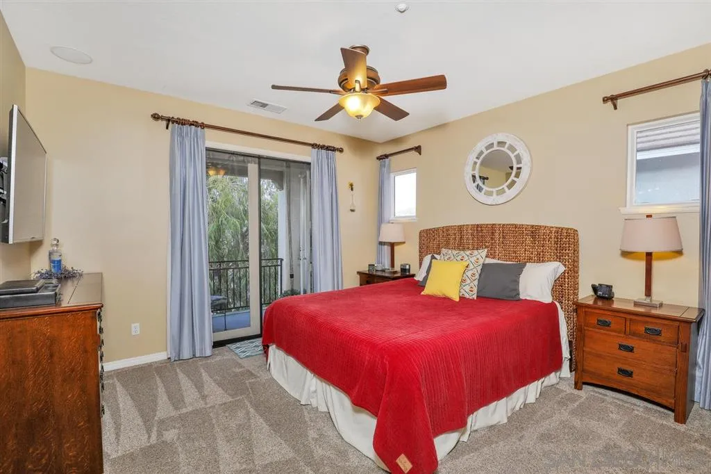 16691 Deer Ridge Road San Diego, CA 92127 - Photo 10 of 20 a bedroom with a bed and a chandelier