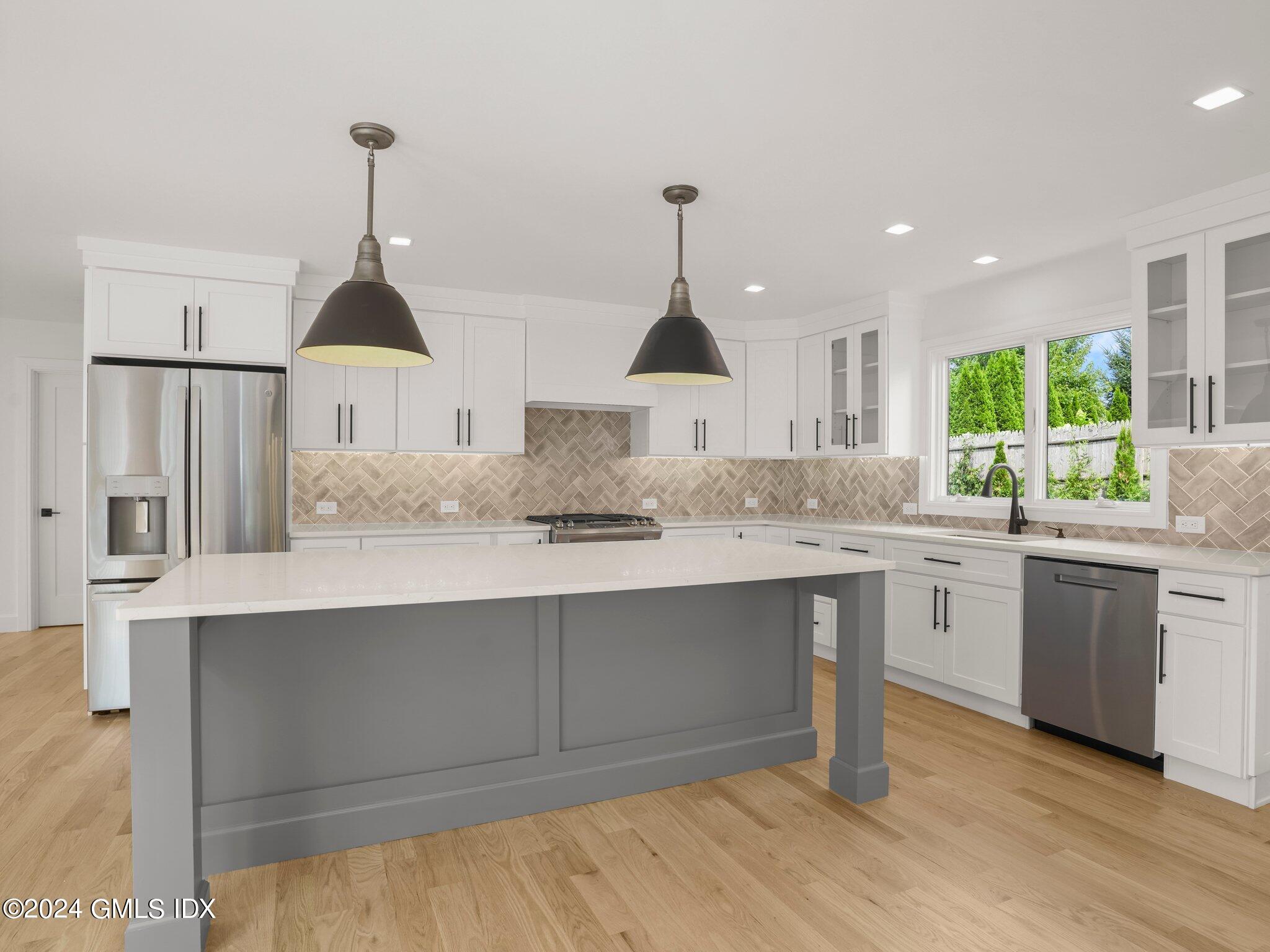 14 Rockland Place Greenwich, CT 06831 - Photo 16 of 54 a kitchen with kitchen island granite countertop a sink and cabinets