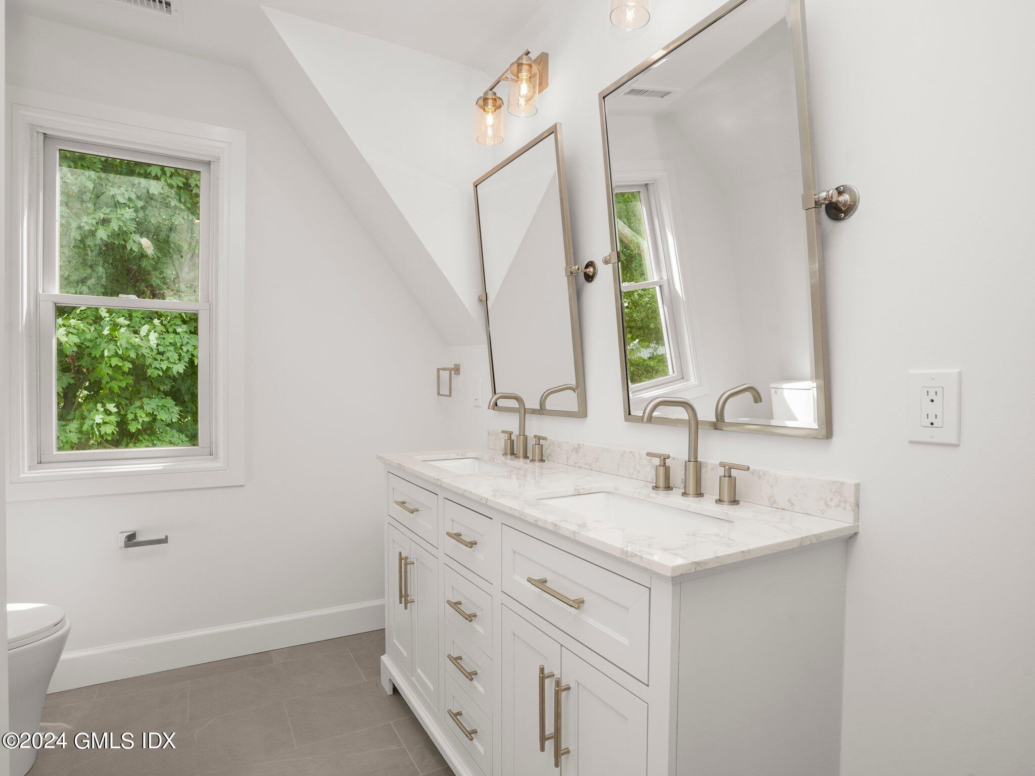 14 Rockland Place Greenwich, CT 06831 - Photo 27 of 54 a bathroom with a sink and a mirror