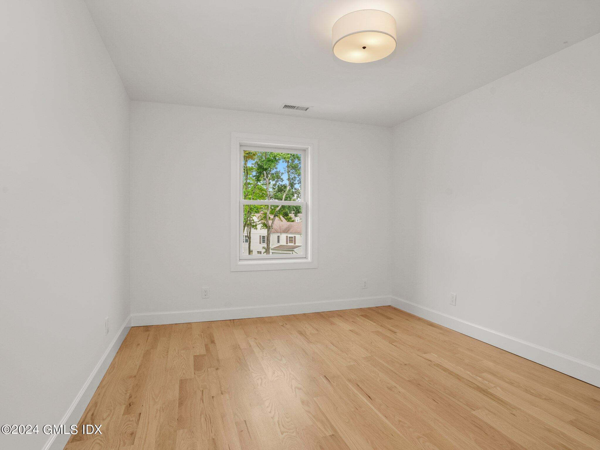 14 Rockland Place Greenwich, CT 06831 - Photo 33 of 54 wooden floor in an empty room with a window