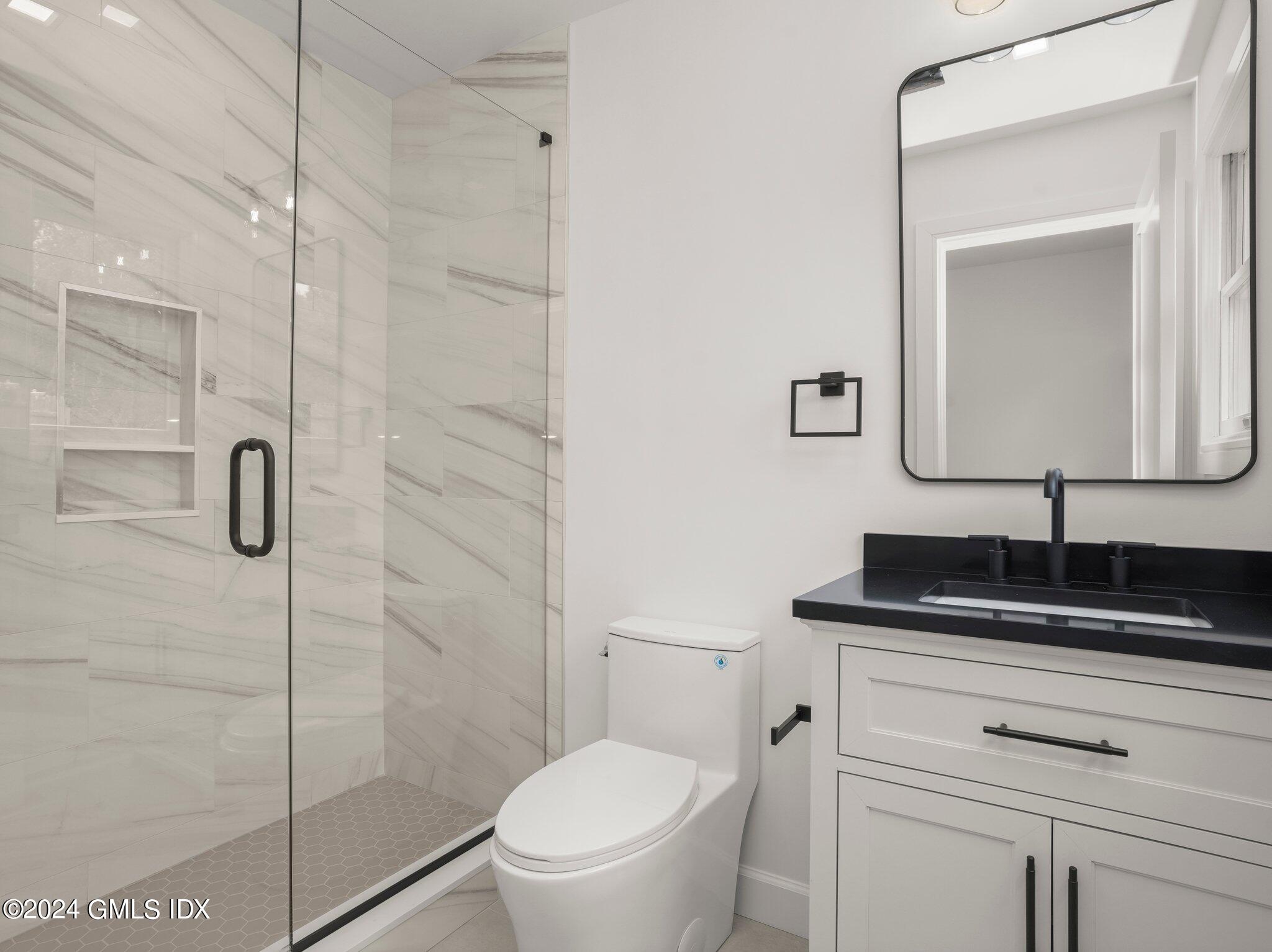 14 Rockland Place Greenwich, CT 06831 - Photo 4 of 54 a bathroom with a granite countertop toilet sink and mirror