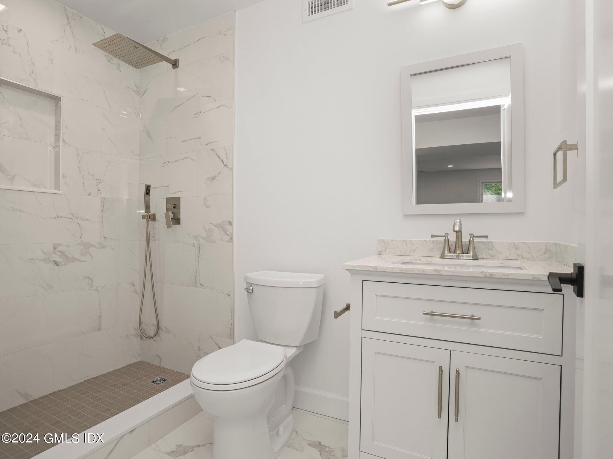 14 Rockland Place Greenwich, CT 06831 - Photo 42 of 54 a bathroom with a sink a toilet and shower