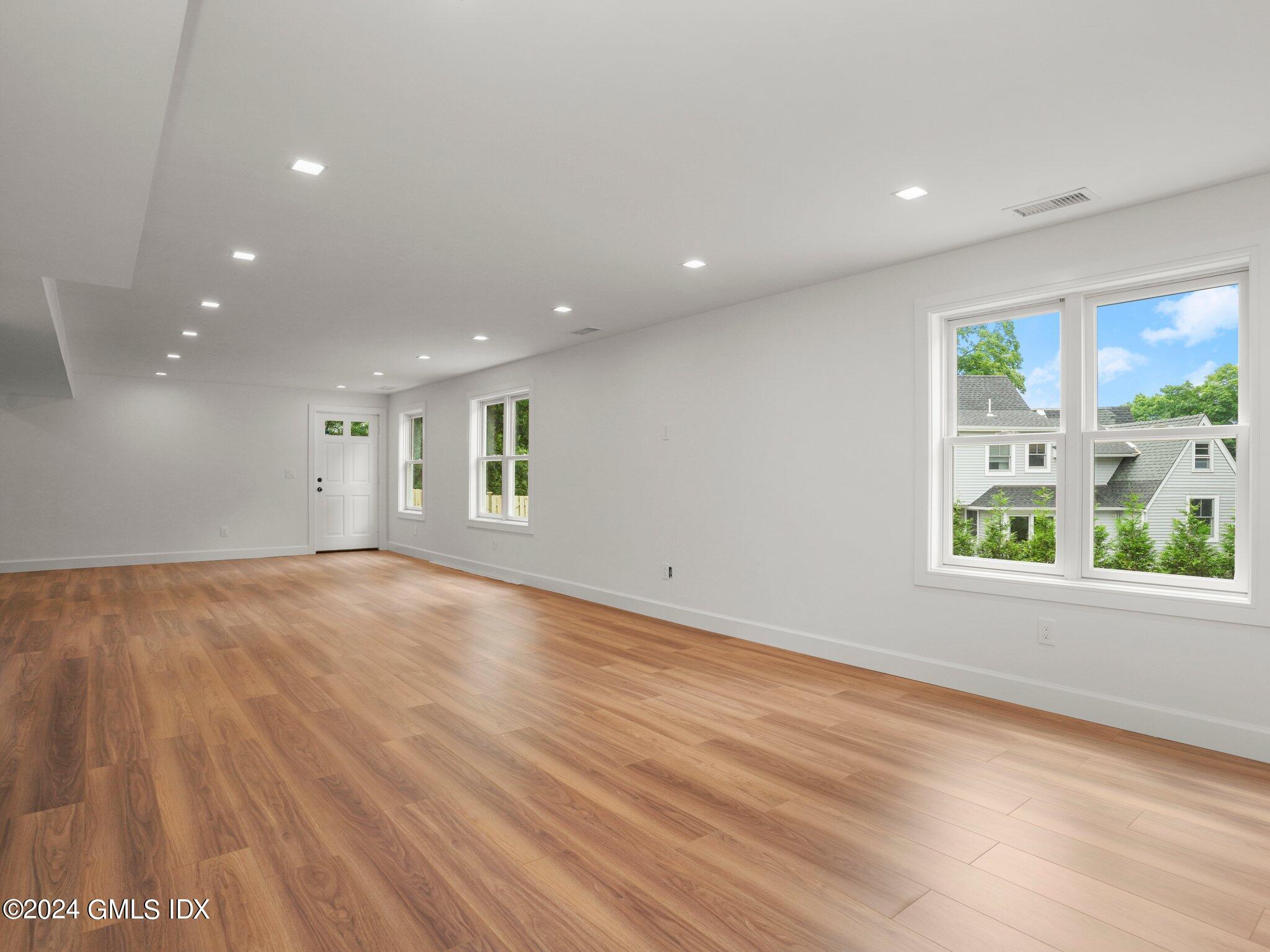 14 Rockland Place Greenwich, CT 06831 - Photo 45 of 54 an empty room with wooden floor and windows