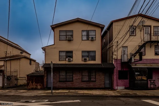 a front view of a house with barbeque and garage