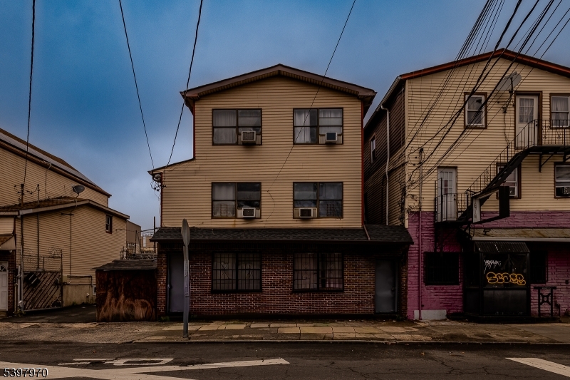 a front view of a house with barbeque and garage