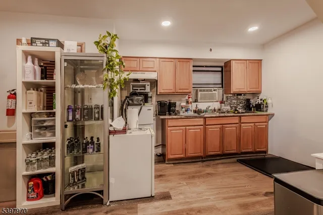 a view of a kitchen with fridge and rack