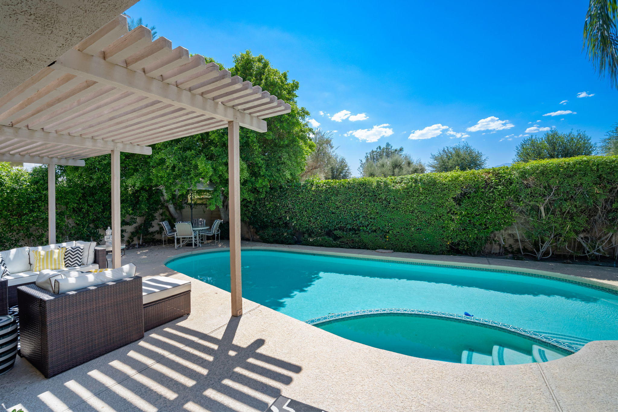 Undisclosed Address Rancho Mirage, CA 92270 - Photo 39 of 52 a view of a patio with a table chairs and a backyard