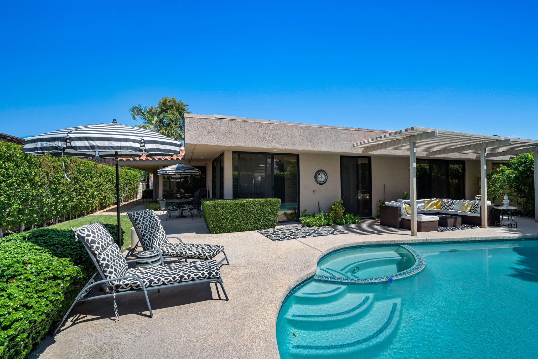 Undisclosed Address Rancho Mirage, CA 92270 - Photo 40 of 52 a view of a house with a backyard patio and swimming pool