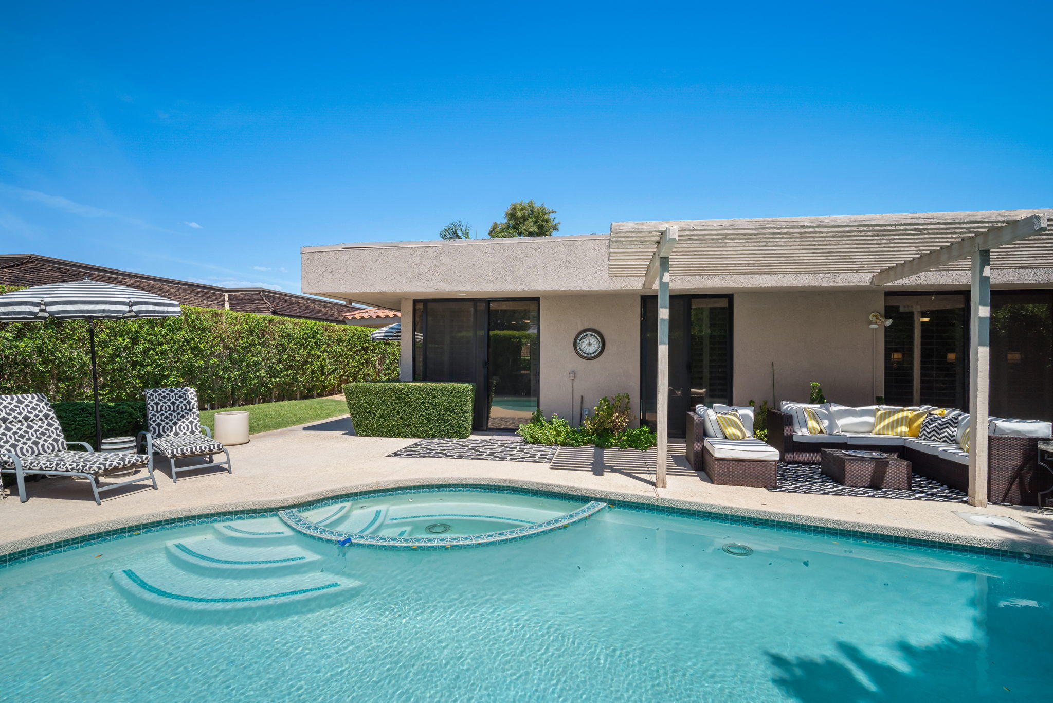 Undisclosed Address Rancho Mirage, CA 92270 - Photo 41 of 52 a view of a house with swimming pool and sitting area