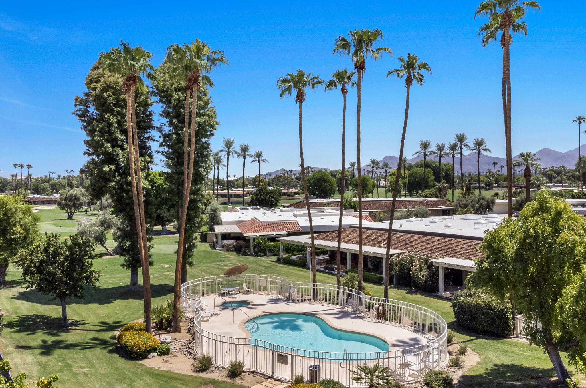 Undisclosed Address Rancho Mirage, CA 92270 - Photo 44 of 52 a view of a swimming pool with a patio and a garden