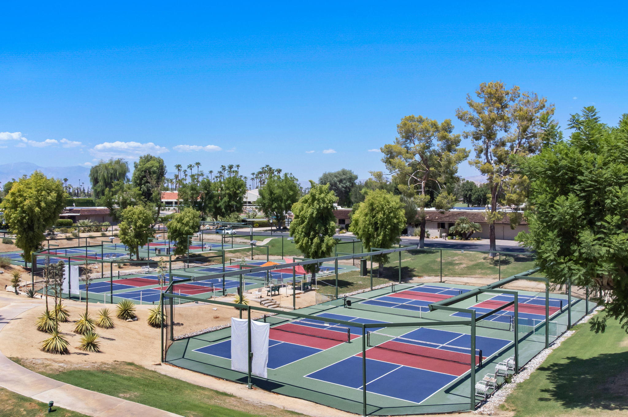 Undisclosed Address Rancho Mirage, CA 92270 - Photo 50 of 52 a wooden bench sitting in a backyard of a building
