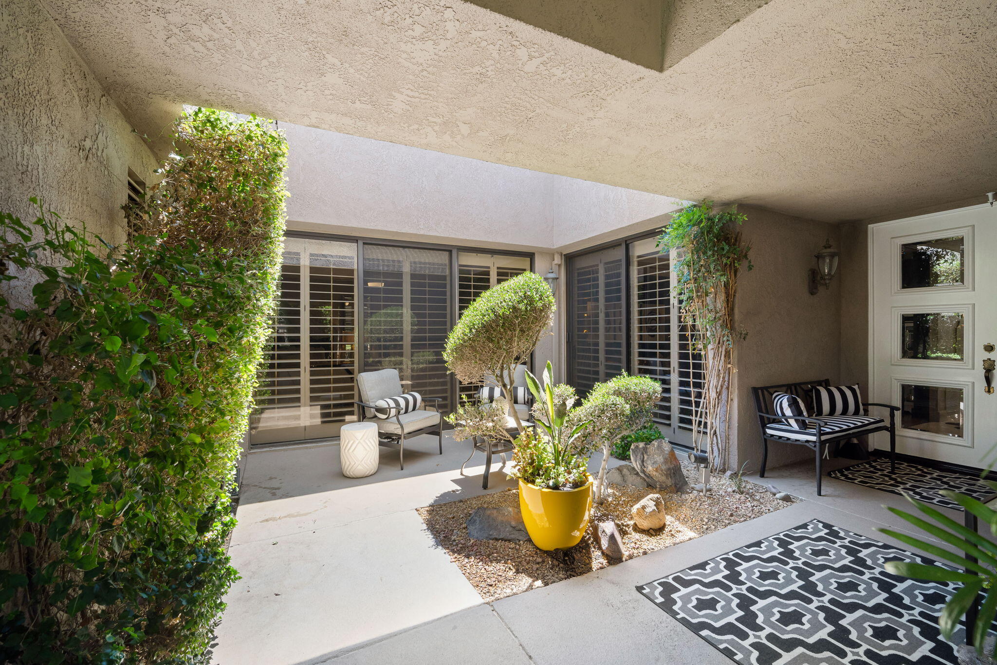 Undisclosed Address Rancho Mirage, CA 92270 - Photo 9 of 52 a view of a patio with table and chairs and potted plants