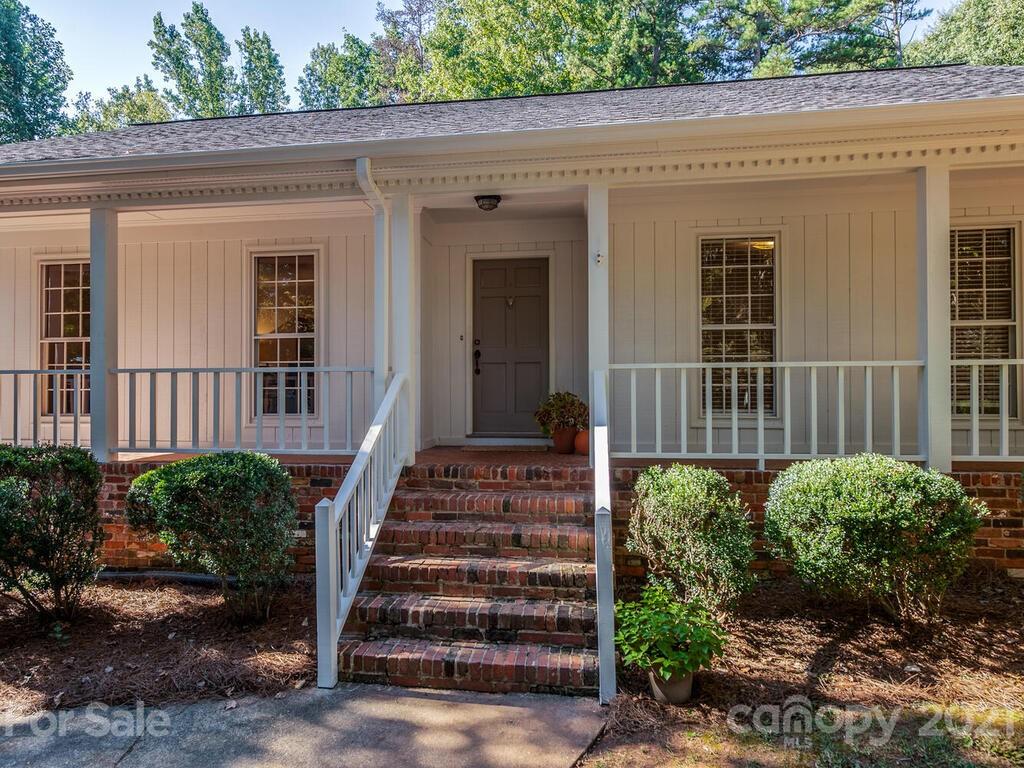 4920 Pine Ridge Road Charlotte, NC 28226 - Photo 2 of 28 a view of a house with a small yard and plants