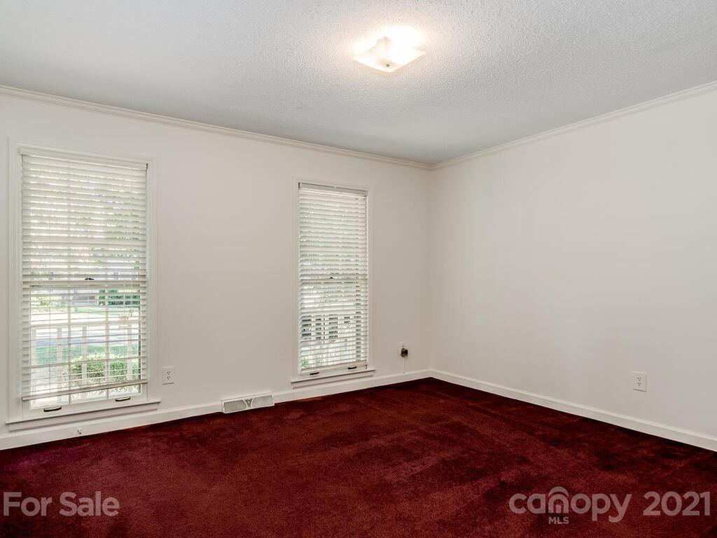 4920 Pine Ridge Road Charlotte, NC 28226 - Photo 17 of 28 an empty room with wooden floor and windows