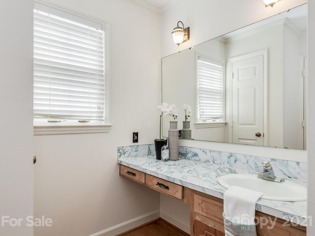 4920 Pine Ridge Road Charlotte, NC 28226 - Photo 22 of 28 a bathroom with a granite countertop sink and a mirror