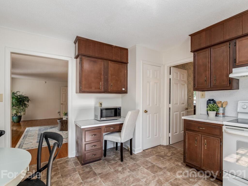 4920 Pine Ridge Road Charlotte, NC 28226 - Photo 8 of 28 a kitchen with a refrigerator and a stove top oven